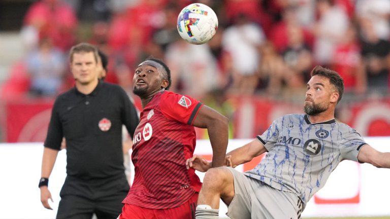 CF Montréal defender Rudy Camacho (4) and Toronto FC forward Ayo Akinola (20) battle for the ball during second half Voyageurs Cup semifinal soccer action against CF Montréal in Toronto on Wednesday, June 22, 2022. (Nathan Denette/CP)