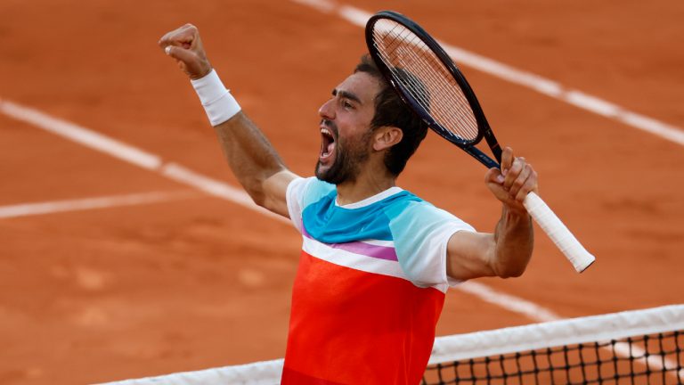 Croatia's Marin Cilic celebrates winning his quarterfinal match against Russia's Andrey Rublev in five sets, 5-7, 6-3, 6-4, 3-6, 7-6 (10-2), at the French Open tennis tournament in Roland Garros stadium in Paris, France, Wednesday, June 1, 2022. (Jean-Francois Badias/AP)