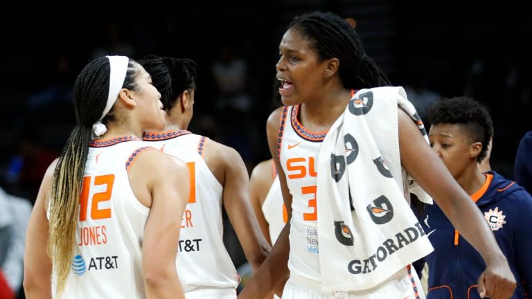 Connecticut Sun center Brionna Jones (42) and forward Jonquel Jones (35) celebrate the team's victory over the the Las Vegas Aces during a WNBA basketball game in Las Vegas on Thursday, June 2, 2022. (Steve Marcus/Las Vegas Sun via AP)