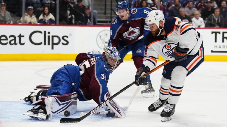 Colorado Avalanche goaltender Darcy Kuemper (35) blocks a shot by Edmonton Oilers right wing Zack Kassian (44) during the first period in Game 1 of the NHL hockey Stanley Cup playoffs Western Conference finals Tuesday, May 31, 2022, in Denver. (AP Photo/Jack Dempsey)