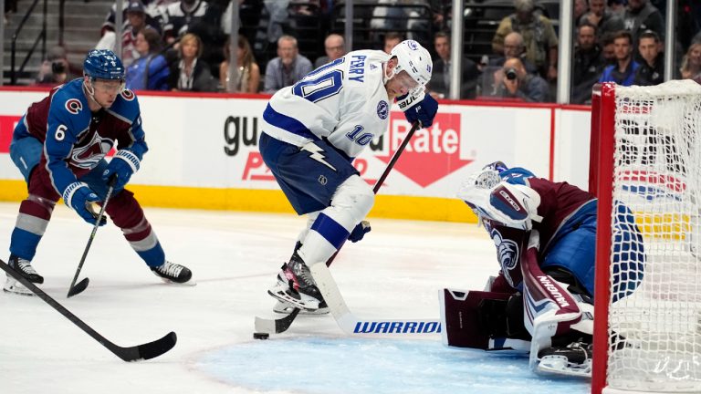 Tampa Bay Lightning right wing Corey Perry (10) controls the puck in front of Colorado Avalanche goaltender Darcy Kuemper during the third period in Game 2 of the NHL hockey Stanley Cup Final on Saturday, June 18, 2022, in Denver. (John Locher/AP)