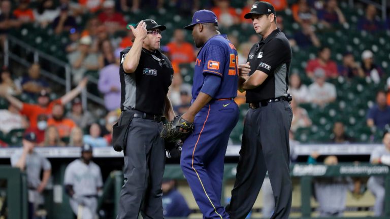 Houston Astros relief pitcher Hector Neris, middle, protests his ejection with umpires Chris Guccione, left, and Jordan Baker, right, after Neris threw at the head of Seattle Mariners batter Eugenio Suarez during the ninth inning of a baseball game Monday, June 6, 2022, in Houston. (Michael Wyke/AP)