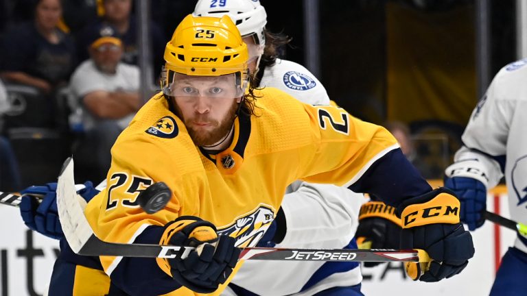 Nashville Predators right wing Mathieu Olivier (25) reaches for the puck during the second period of an NHL hockey preseason game against the Tampa Bay Lightning, Saturday, Oct. 2, 2021, in Nashville, Tenn. (Mark Zaleski/AP)