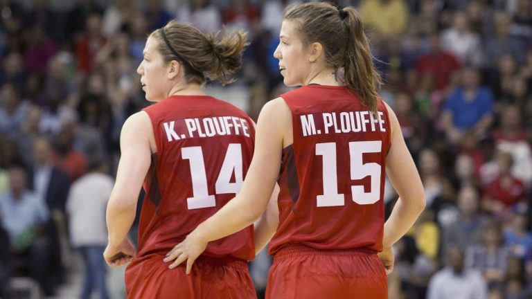 Michelle Plouffe (right) jogs back to her defensive position with sister Katherine during women's basketball action against Argentina at the Pan Am games in Toronto on Friday, July 17, 2015. Katherine and Michelle Plouffe raised some eyebrows when they announced their retirement from Canada's women's basketball team earlier this year. (Chris Young/CP)