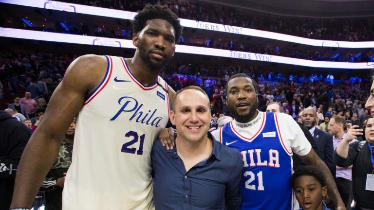 FILE - Philadelphia 76ers' Joel Embiid, of Cameroon, poses for a photo with 76ers' co-owner Michael Rubin, center left, Rapper Meek Mill, center right, and his son, right, after Game 5 of a first-round NBA basketball playoff series between the Miami Heat and the Philadelphia 76ers, Tuesday, April 24, 2018, in Philadelphia. Fanatics founder Michael Rubin is selling his stake in the ownership company that owns the Philadelphia 76ers and New Jersey Devils. (Chris Szagola/AP)