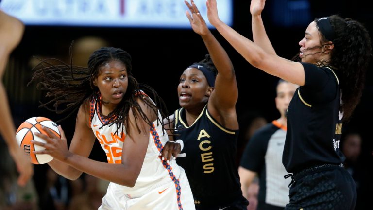 Connecticut Sun forward Jonquel Jones (35) is guarded by Las Vegas Aces guard Chelsea Gray (12) and forward Dearica Hamby, right, during a WNBA basketball game in Las Vegas on Thursday, June 2, 2022. (Steve Marcus/Las Vegas Sun via AP)