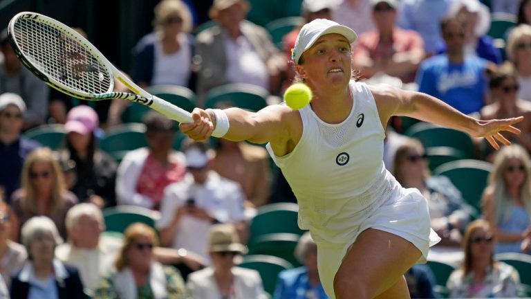 Poland's Iga Swiatek returns to Croatia's Jana Fett in a first round women's singles match on day two of the Wimbledon tennis championships in London, Tuesday, June 28, 2022. (Alberto Pezzali/AP)