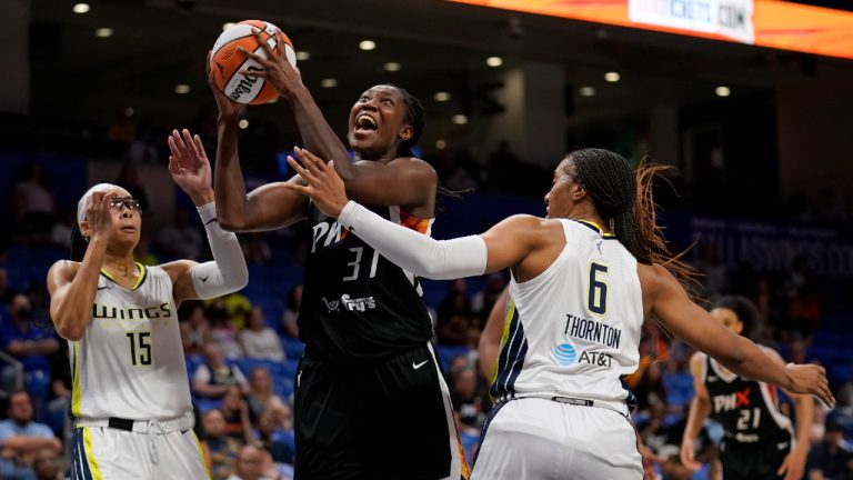 Phoenix Mercury center Tina Charles (31) shoots from between Dallas Wings' Allisha Gray (15) and Kayla Thornton (6) during the second half of a WNBA basketball game Friday, June 17, 2022, in Arlington, Texas. (Tony Gutierrez/AP)