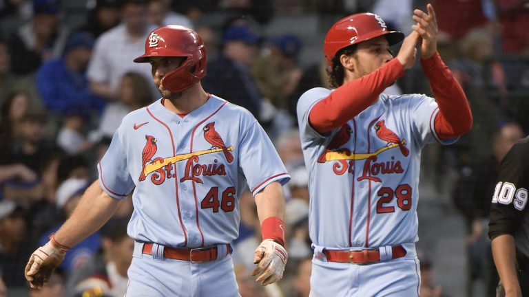 St. Louis Cardinals Paul Goldschmidt (46) and Nolan Arenado (28) celebrate after scoring on a hit by Brendan Donovan during the fourth inning against the Chicago Cubs in the second game of a baseball doubleheader, Saturday, June 4, 2022, at Wrigley Field in Chicago. (AP Photo/Mark Black)