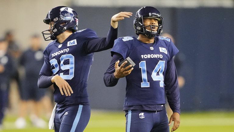 Toronto Argonauts' Boris Bede reacts to missing an extra point attempt to tie the game late in the fourth quarter with teammate John Haggerty, left, during CFL football action against the  Winnipeg Blue Bombers, in Toronto, Monday, July 4, 2022. (Mark Blinch/CP)