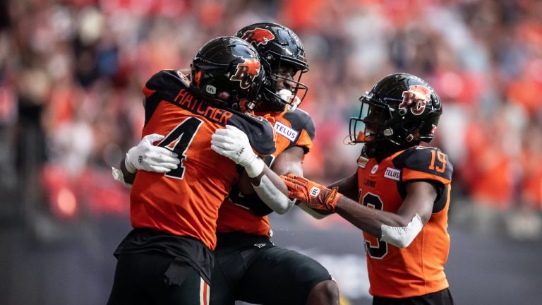 B.C. Lions' Keon Hatcher, from left to right, Jevon Cottoy and Dominique Rhymes celebrate Cottoy's touchdown against the Hamilton Tiger-Cats during the first half of CFL football game in Vancouver. (Darryl Dyck/CP)