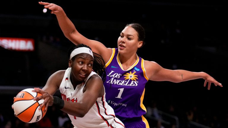 Washington Mystics center Elizabeth Williams, left, gets a rebound next to Los Angeles Sparks center Liz Cambage during the first half of a WNBA basketball game Tuesday, July 12, 2022, in Los Angeles. (Keith Birmingham/The Orange County Register via AP)