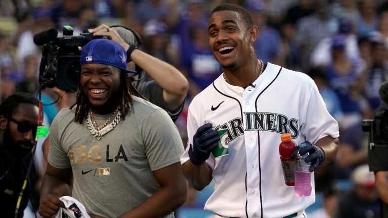 American League's Julio Rodriguez, of the Seattle Mariners, right, smiles next to Toronto Blue Jays' Vladimir Guerrero Jr. during the MLB All-Star baseball Home Run Derby, Monday, July 18, 2022, in Los Angeles. (AP Photo/Mark J. Terrill)