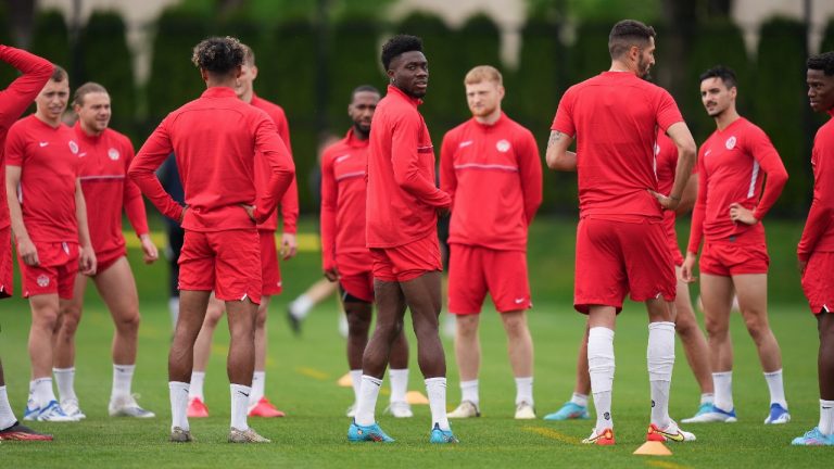 Canadian national men's soccer team forward Alphonso Davies, centre, stands with his teammates during a training session for a CONCACAF Nations League match against Curacao. (Darryl Dyck/CP)