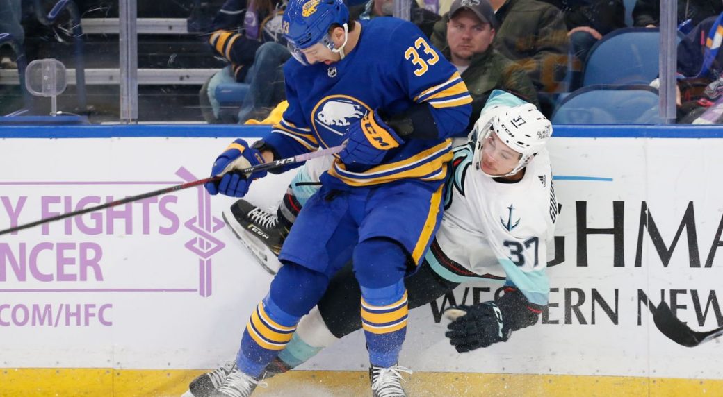 Seattle-Kraken-centre-Yanni-Gourde-is-checked-by-Buffalo-Sabres-defenceman-Colin-Miller-during-the-2021-22-NHL-season