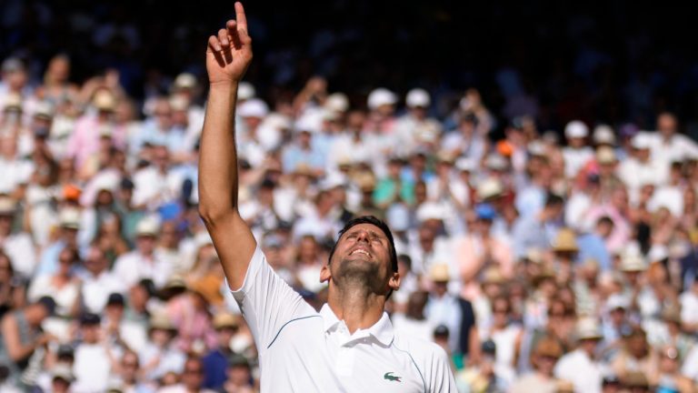 Serbia's Novak Djokovic celebrates beating Australia's Nick Kyrgios in the final of the men's singles on day fourteen of the Wimbledon tennis championships in London, Sunday, July 10, 2022. (Kirsty Wigglesworth/AP)