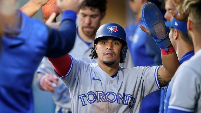 Toronto Blue Jays' Santiago Espinal is greeted in the dugout after he scored on a single by Bo Bichette against the Seattle Mariners during the fifth inning of a baseball game Thursday, July 7, 2022, in Seattle. (Ted S. Warren/AP)