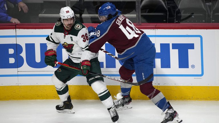 Colorado Avalanche defenceman Dennis Gilbert, right, chases Minnesota Wild right wing Mats Zuccarello in the first period of a preseason NHL hockey game. (David Zalubowski/AP)