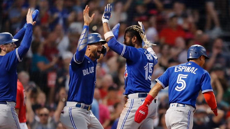 Toronto Blue Jays' Raimel Tapia (15) celebrates his inside-the-park grand slam that scored Lourdes Gurriel Jr., center left, Danny Jansen, left, and Santiago Espinal (5) during the third inning of the team's baseball game against the Boston Red Sox, Friday, July 22, 2022, in Boston. (Michael Dwyer/AP)