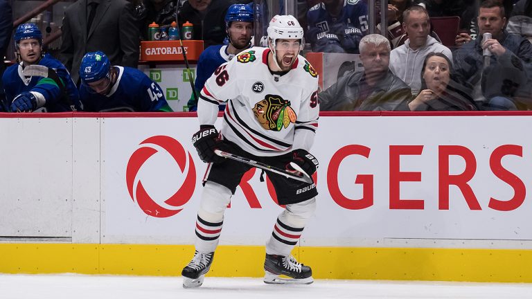 Chicago Blackhawks' Erik Gustafsson, of Sweden, celebrates Brandon Hagel's goal against the Vancouver Canucks during third period NHL hockey action in Vancouver, B.C. (Darryl Dyck/CP)