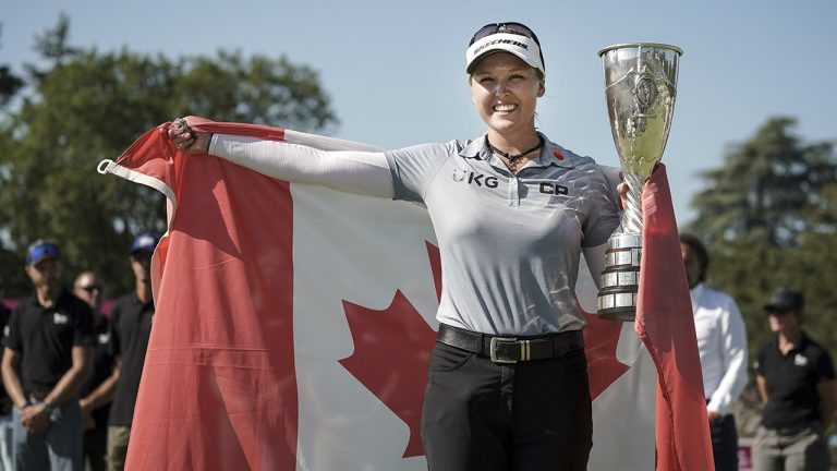 Brooke Henderson celebrates with her trophy after winning the Evian Championship women's golf tournament in July of 2022. (Laurent Cipriani/AP)