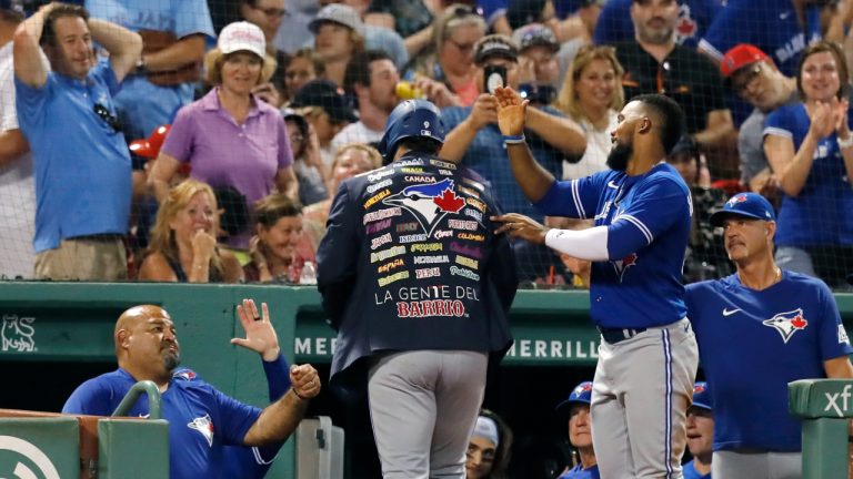 Toronto Blue Jays' Danny Jansen, centre, celebrates his three-run home run with Teoscar Hernandez, right, during the fourth inning of the team's baseball game against the Boston Red Sox, Friday, July 22, 2022, in Boston. (Michael Dwyer/AP)