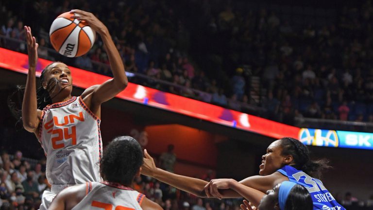 Connecticut Sun forward DeWanna Bonner (24) pulls down the defensive rebound over teammate Alyssa Thomas (25) and Chicago Sky guard Kahleah Copper, front right, and forward Azura Stevens, back right, during a WNBA basketball game in Uncasville, Conn., Sunday, July 31, 2022. (Sean D. Elliot/AP)