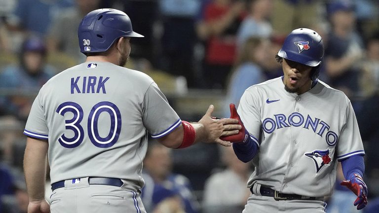 Toronto Blue Jays' Santiago Espinal, right, celebrates with Alejandro Kirk (30) after hitting a two-run home run during the sixth inning of a baseball game against the Kansas City Royals. (Charlie Riedel/AP)