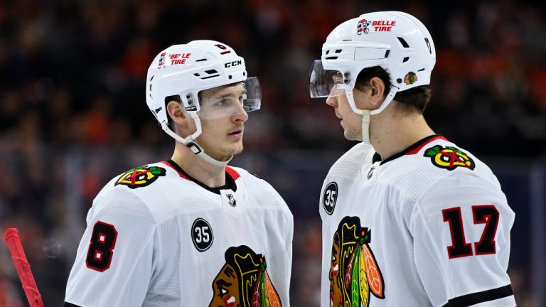 Chicago Blackhawks' Dominik Kubalik, left, talks to Dylan Strome during an NHL hockey game against the Philadelphia Flyers. (Derik Hamilton/AP)