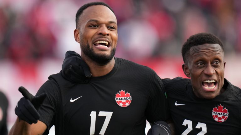 Canada's Cyle Larin, 17, celebrates his goal against the USA with teammate Richie Laryea, 22, during a men's first half World Cup Qualifier at sold out Tim Hortons Field in Hamilton, Ontario on Sunday Jan. 30, 2022. (Nathan Denette/CP)