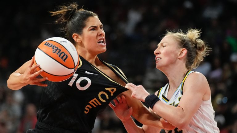 Chicago Sky guard Courtney Vandersloot, right, fouls Las Vegas Aces guard Kelsey Plum (10) during the second half of a WNBA basketball game Tuesday, June 21, 2022, in Las Vegas. (John Locher/AP)