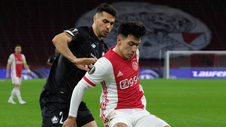 Ajax's Lisandro Martinez, right, fights for the ball with Lille's Zeki Celik during the Europa League round of 32 second leg soccer match between Ajax and Lille at the Johan Cruyff ArenA in Amsterdam, Netherlands, Thursday, Feb. 25, 2021. (Patrick Post/AP)