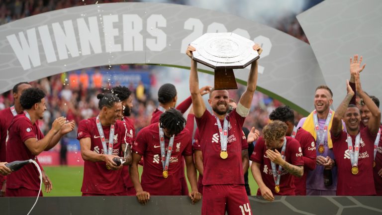 Liverpool's Jordan Henderson holds up the trophy after winning the FA Community Shield soccer match between Liverpool and Manchester City at the King Power Stadium in Leicester, England. (Frank Augstein/AP)