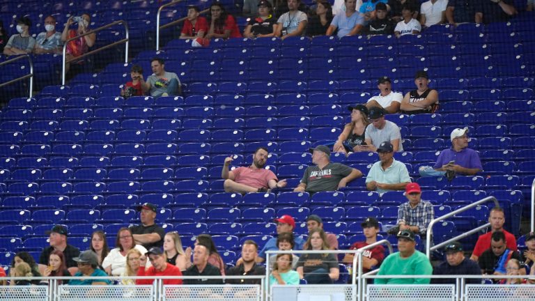 Baseball fans look on during the first inning of a baseball game between the Miami Marlins and the Texas Rangers, Thursday, July 21, 2022, in Miami. (Wilfredo Lee/AP)