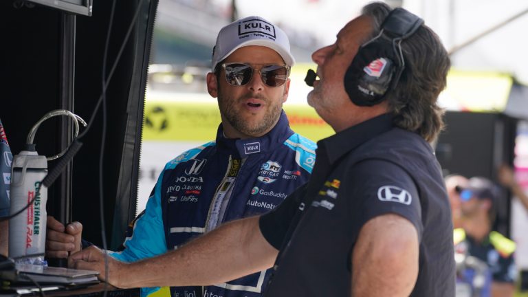 Marco Andretti, left, talks with Michael Andretti during practice for the Indianapolis 500 auto race at Indianapolis Motor Speedway, Thursday, May 19, 2022, in Indianapolis. (Darron Cummings/AP)