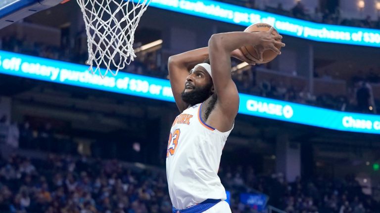 New York Knicks center Mitchell Robinson (23) dunks against the Golden State Warriors during the first half of an NBA basketball game in San Francisco, Thursday, Feb. 10, 2022. (AP Photo/Jeff Chiu)