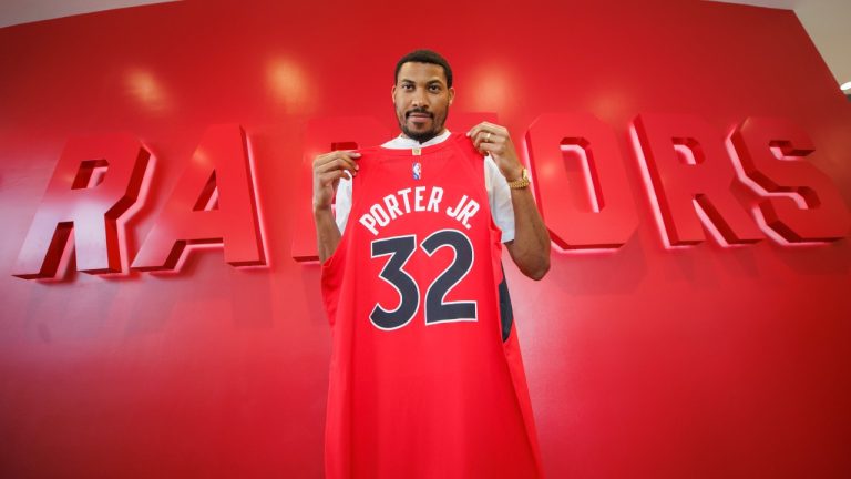 Former Toronto Raptors player Otto Porter Jr. poses with his jersey following a press conference at the team's practice facility in Toronto, Wed. July 6, 2022. (Cole Burston/CP)