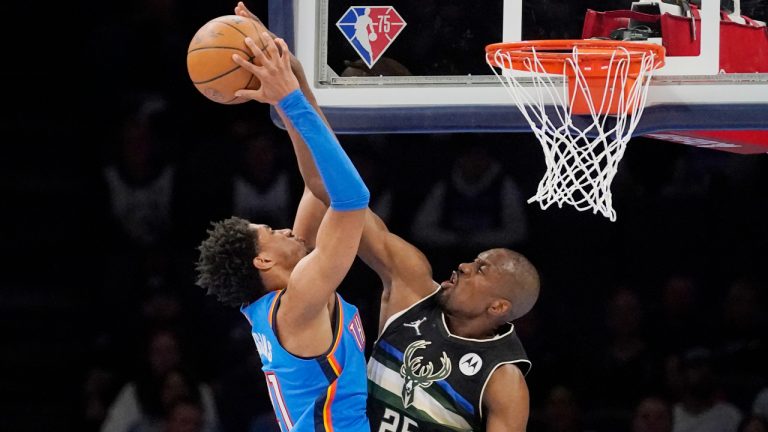 Milwaukee Bucks center Serge Ibaka (25) blocks a shot by Oklahoma City Thunder guard Aaron Wiggins, left, in the second half of an NBA basketball game Tuesday, March 8, 2022, in Oklahoma City. (Sue Ogrocki/AP)