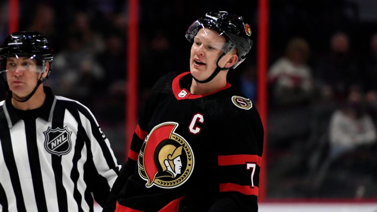 Ottawa Senators' Brady Tkachuk (7) is escorted off the ice after a penalty against the Los Angeles Kings in the final minute of third period NHL hockey action in Ottawa, on Thursday, Nov. 11, 2021. (Justin Tang/CP)