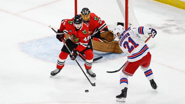 Former Chicago Blackhawks defenseman Wyatt Kalynuk (48) defends against New York Rangers right wing Barclay Goodrow (21) during the first period of an NHL hockey game, Tuesday, Dec. 7, 2021, in Chicago. (Kamil Krzaczynski/AP)