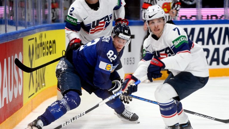 Harri Pesonen of Finland, left, and Nick Blankenburg of USA in action during the 2022 IIHF Ice Hockey World Championships preliminary round group B match between Finland and USA in Tampere, Finland, Monday May 16, 2022. (Vesa Moilanen/Lehtikuva via AP)