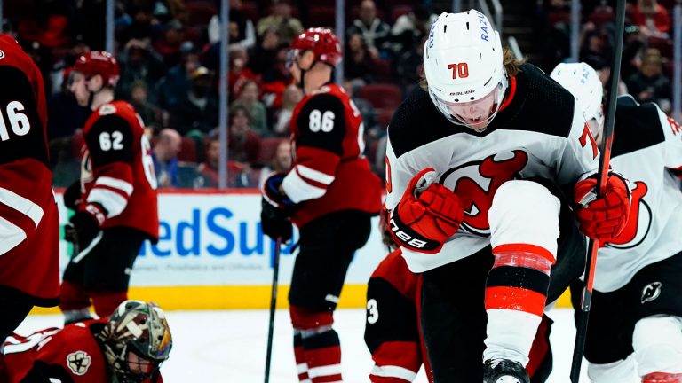 New Jersey Devils center Jesper Boqvist, front, celebrates his goal against Arizona Coyotes goaltender Karel Vejmelka, lower left, as Coyotes defensemen J.J. Moser (62) and Anton Stralman (86) pause on the ice during the second period of an NHL hockey game. (Ross D. Franklin/AP)