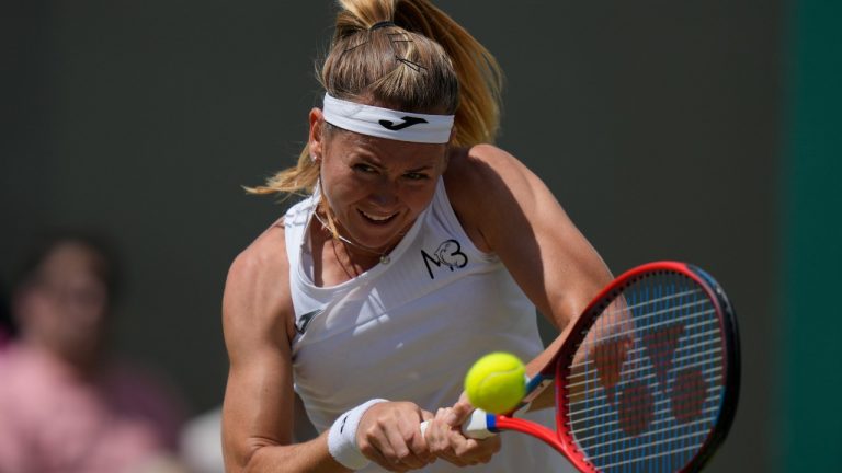 Marie Bouzkova of the Czech Republic plays a return to France's Caroline Garcia in a fourth round women's singles match on day seven of the Wimbledon tennis championships in London, Sunday July 3, 2022. (Alastair Grant/AP)