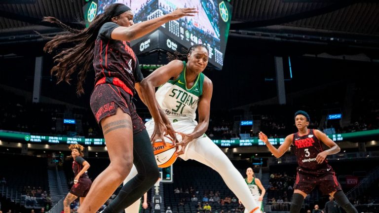 Indiana Fever's Queen Egbo, left, defends against Seattle Storm's Tina Charles during the first half of a WNBA basketball game Friday, July 1, 2022, in Seattle. (Dean Rutz/The Seattle Times via AP)