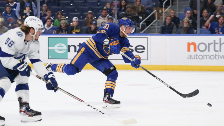 Buffalo Sabres centre Drake Caggiula (91) shoots and scores a goal while defended by Tampa Bay Lightning defenceman Mikhail Sergachev (98) during the second period of an NHL hockey game Monday, Oct. 25, 2021, in Buffalo, N.Y. (Joshua Bessex/AP)