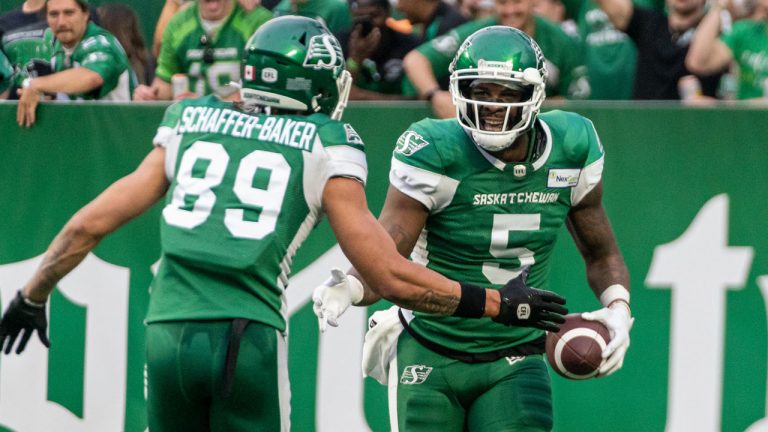 Saskatchewan Roughriders receiver D'haquille Williams (5) celebrates a two point conversion with teammate Kian Schaffer-Baker (89) during second half CFL football action. (Heywood Yu/CP)