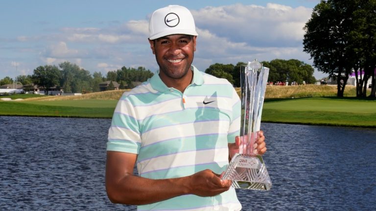 Tony Finau poses for photos with the trophy after his win in the 3M Open golf tournament at the Tournament Players Club in Blaine, Minn., Sunday, July 24, 2022. (Abbie Parr/AP)