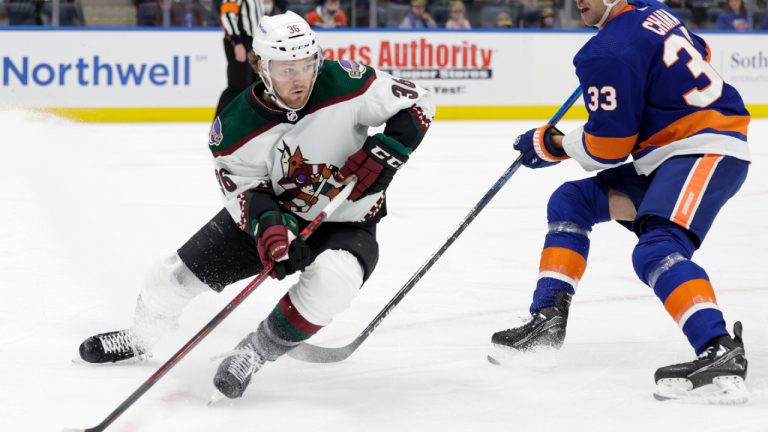 Arizona Coyotes right wing Christian Fischer (36) skates around New York Islanders defenseman Zdeno Chara (33) during the first period of an NHL hockey game, Friday, Jan. 21, 2022, in Elmont, N.Y. (Corey Sipkin/AP).