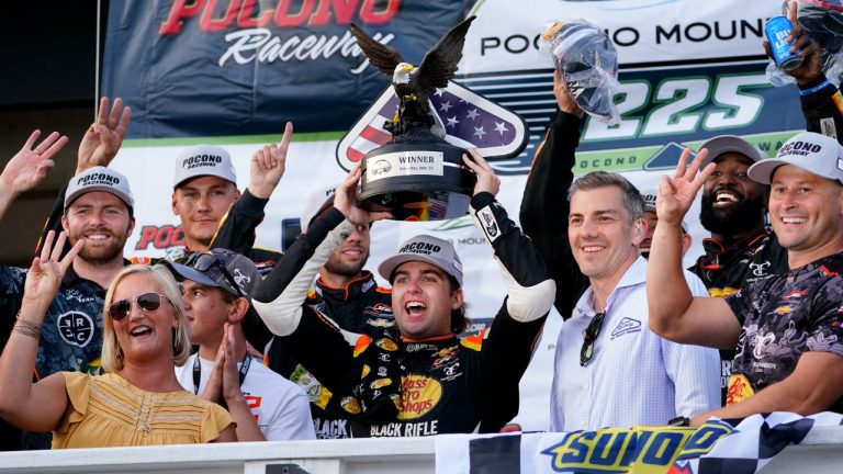 Noah Gragson, centre, celebrates with the trophy after he won the NASCAR Xfinity Series auto race at Pocono Raceway, Saturday, July 23, 2022 in Long Pond, Pa. (Matt Slocum/AP)