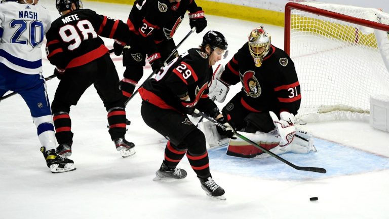 Ottawa Senators defenceman Dillon Heatherington (29) controls the puck in front of goaltender Anton Forsberg (31) during third period NHL hockey action against the Tampa Bay Lightning in Ottawa, on Saturday, Dec. 11, 2021. (Justin Tang/CP)